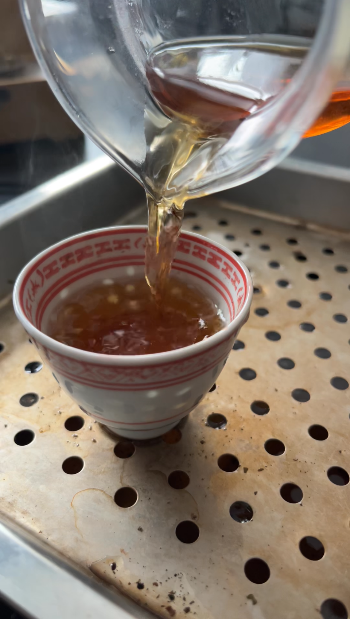 Action shot of tea pouring into the cup during a late steep