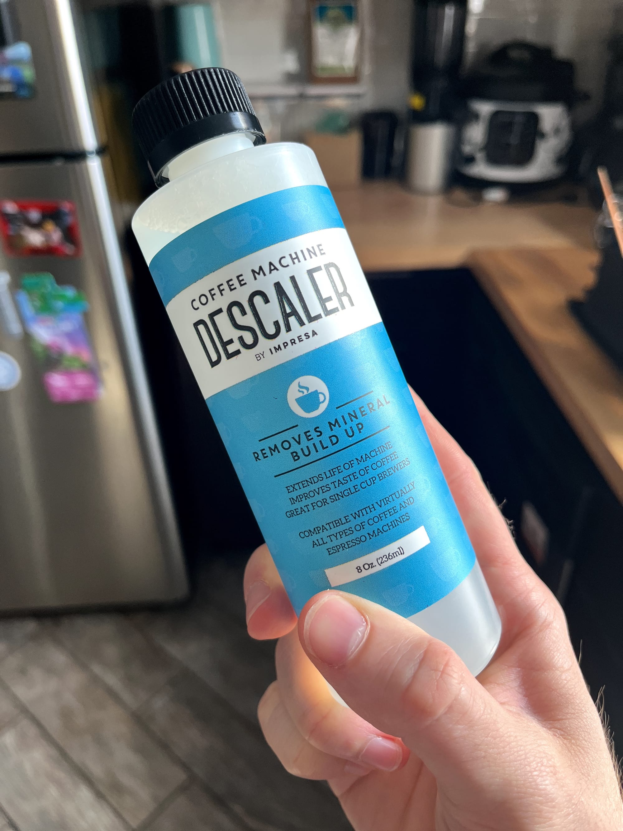 A bottle of descaler solution for coffee machines.
