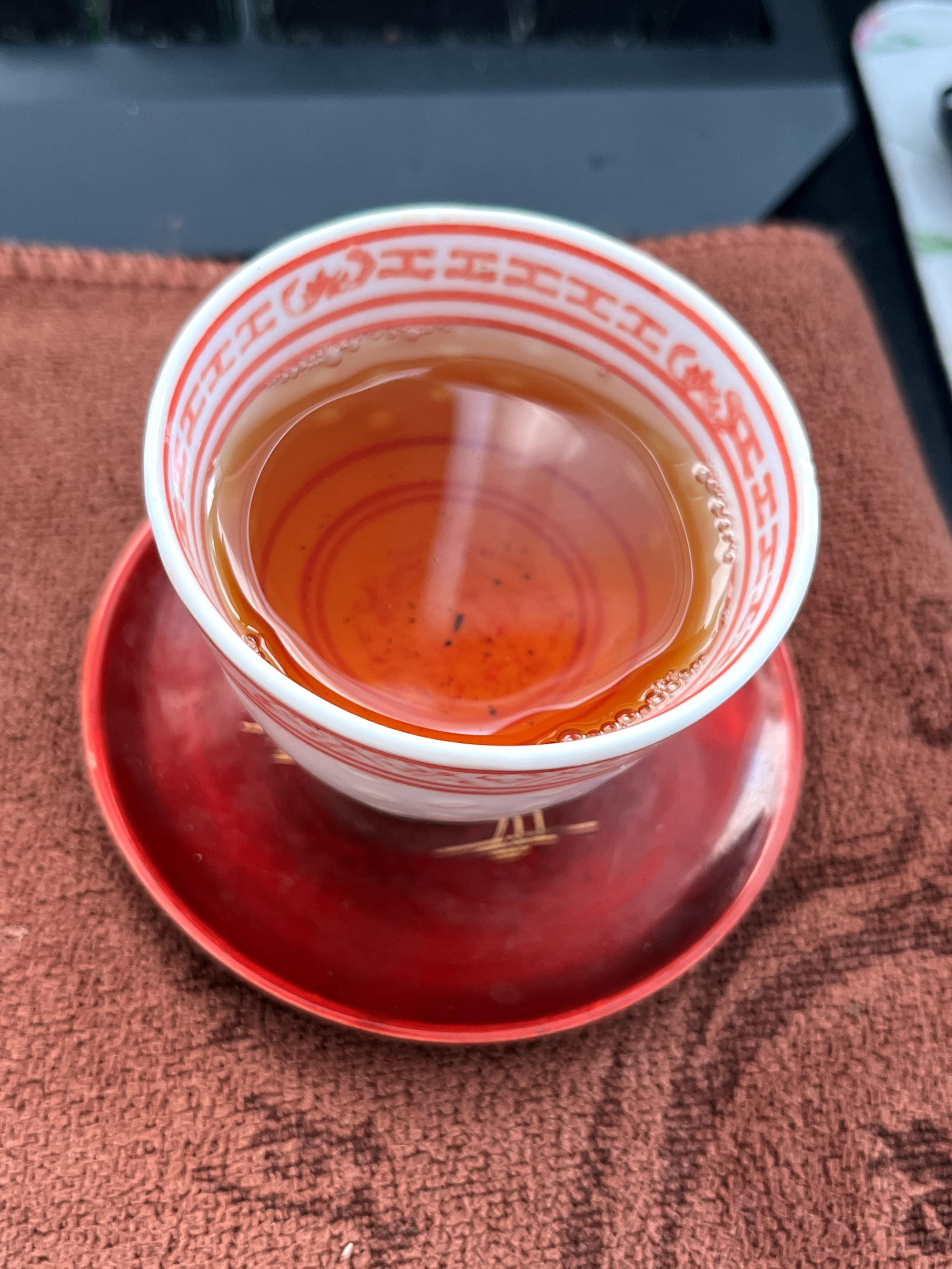 A beautiful, deep, orange color of tea liquor in the cup.